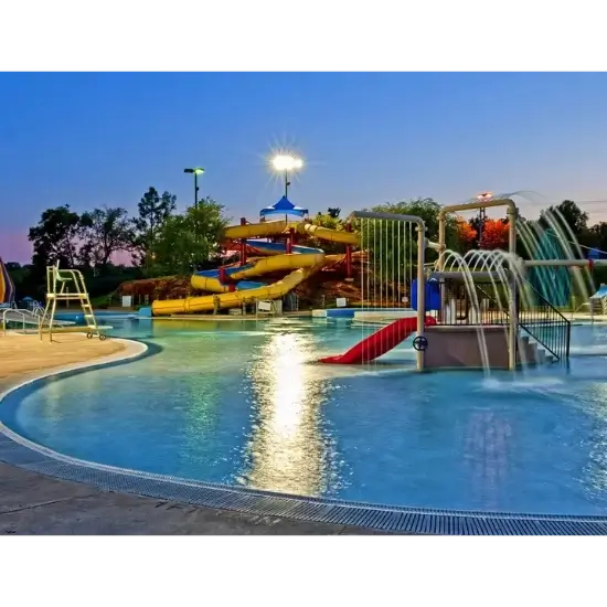 Colorful Pelican Bay in Edmond, OK, water park slides at sunset.