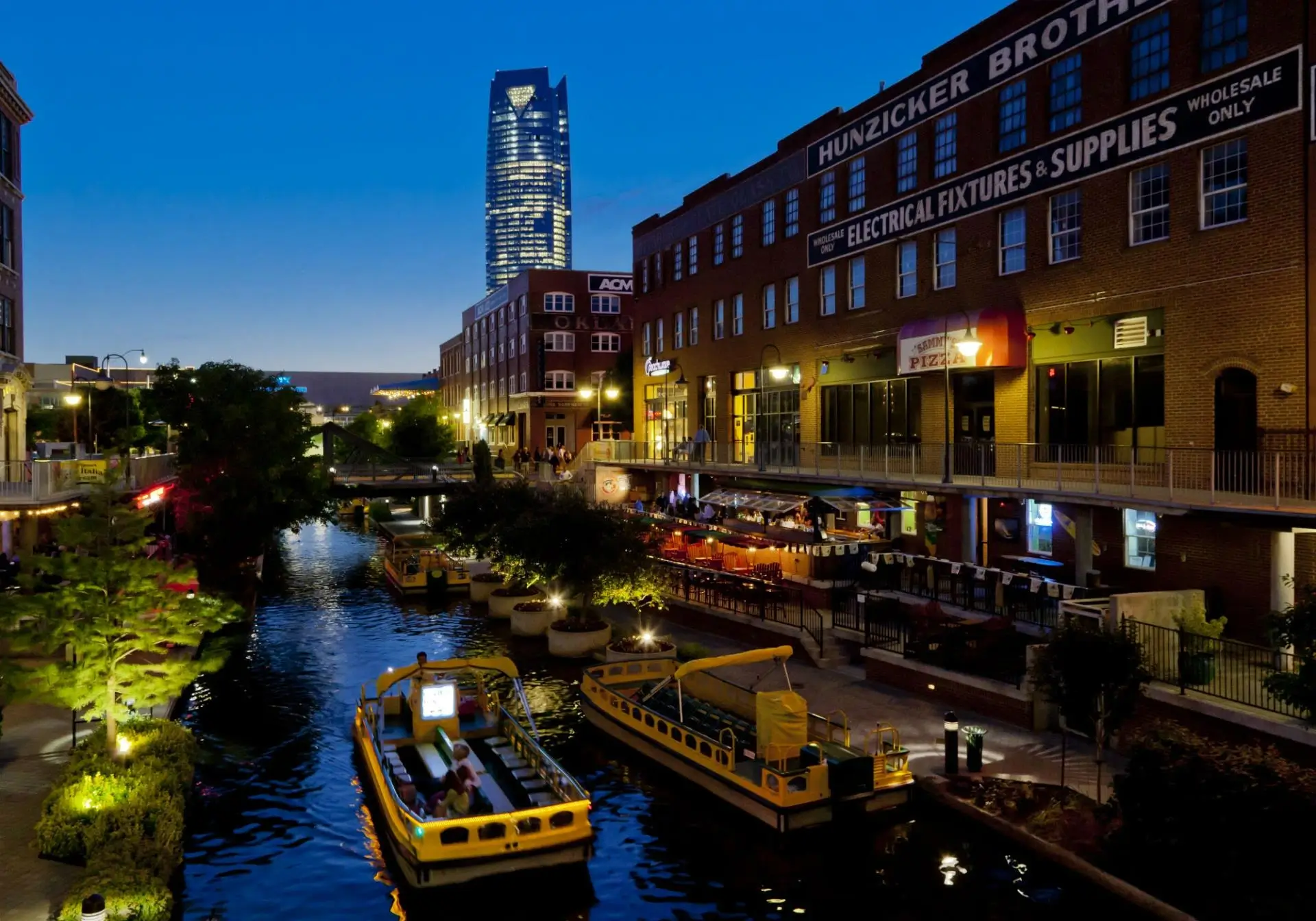 Downtown canal with boats and city skyline at night. Bricktown Oklahoma City at night.