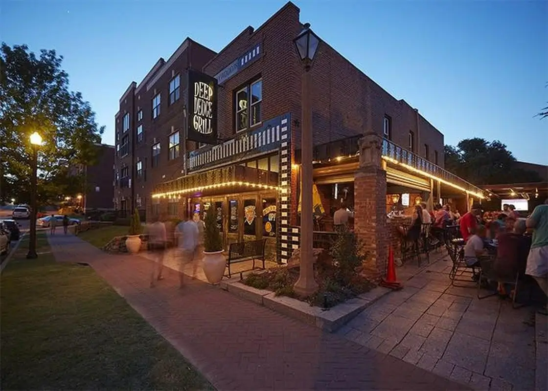 Restaurant exterior with evening diners and lights. deep deuce district oklahoma city travelok com