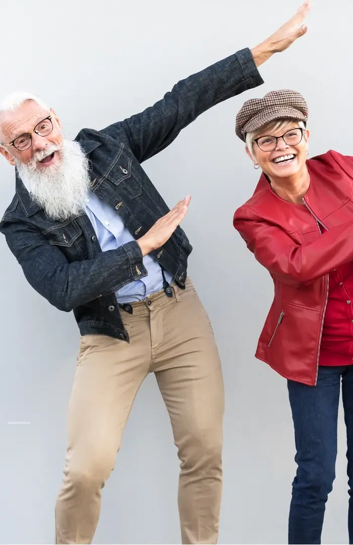 Two cheerful adults dancing together.