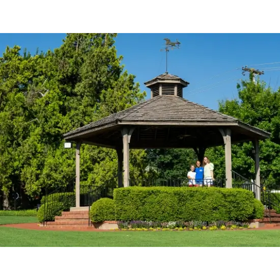 Gazebo in a sunny park with people