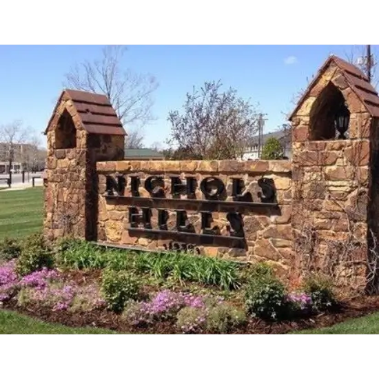Nichols Hills stone entrance sign with flowers