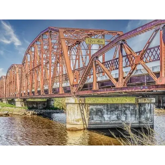 Historic Overholser Bridge Bethany Ok over river, clear sky background.