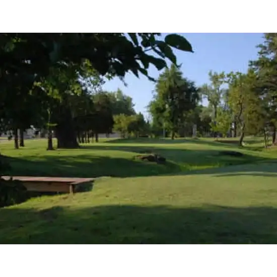 Pebble Creek Golf course in Mustang, OK on a sunny day with lush trees