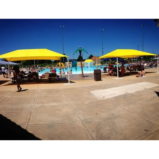 Reno swim and slide midwest city, ok. Outdoor pool with yellow umbrellas and swimmers.