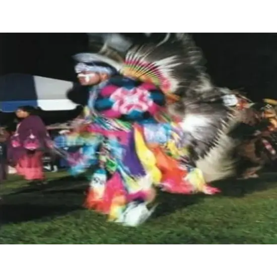 Tinker Inter-Tribal Council Powwow in Midwest City, OK. Traditional dance in colorful regalia at night festival.