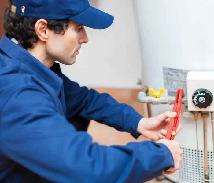 800x600 Plumber fixing water heater with wrench