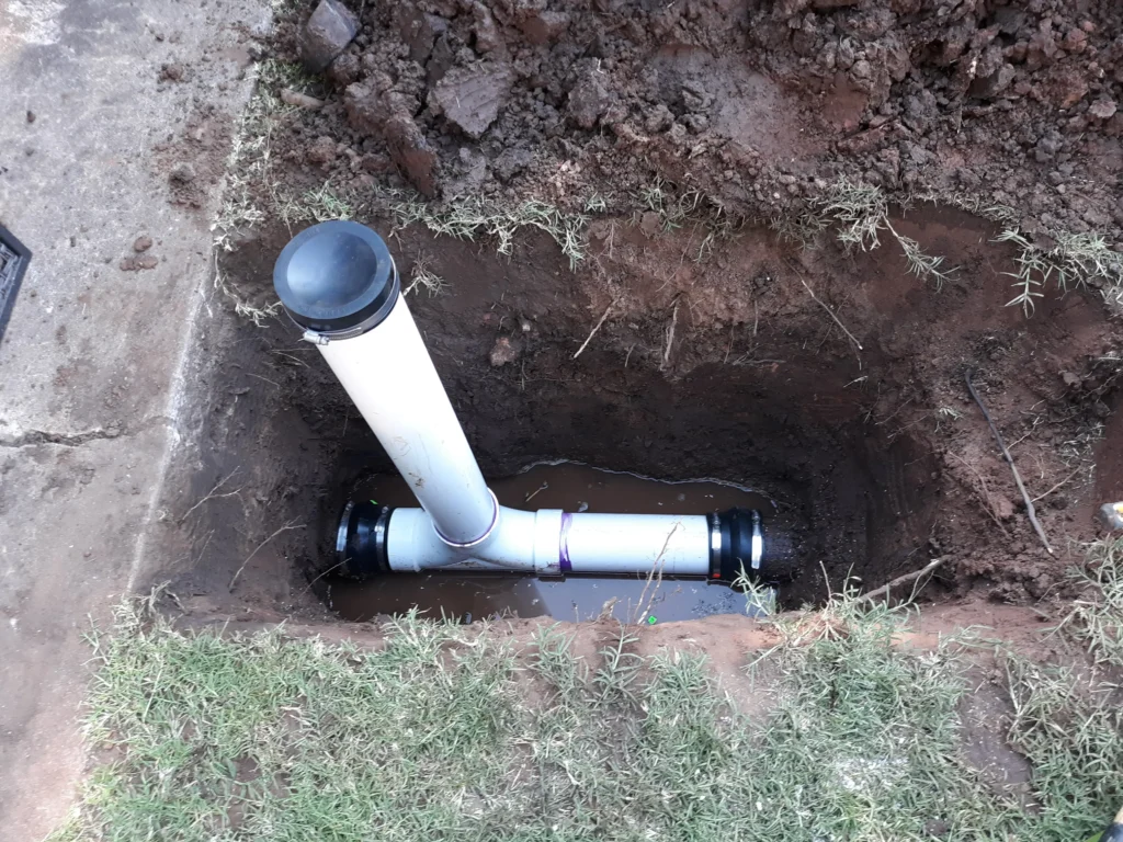 Installed drainage pipe in a dug trench.