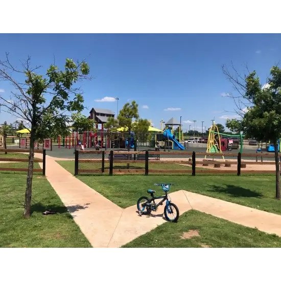 Wild Horse Park in Mustang, OK. Sunny playground with slide and bike.