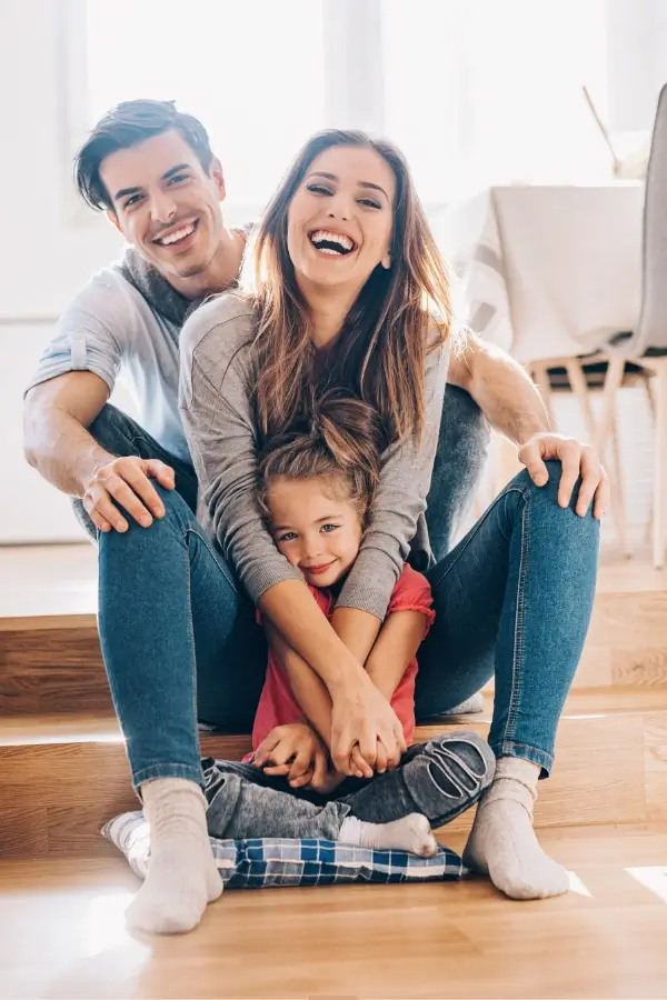 800x1080 Happy family sitting together on stairs.